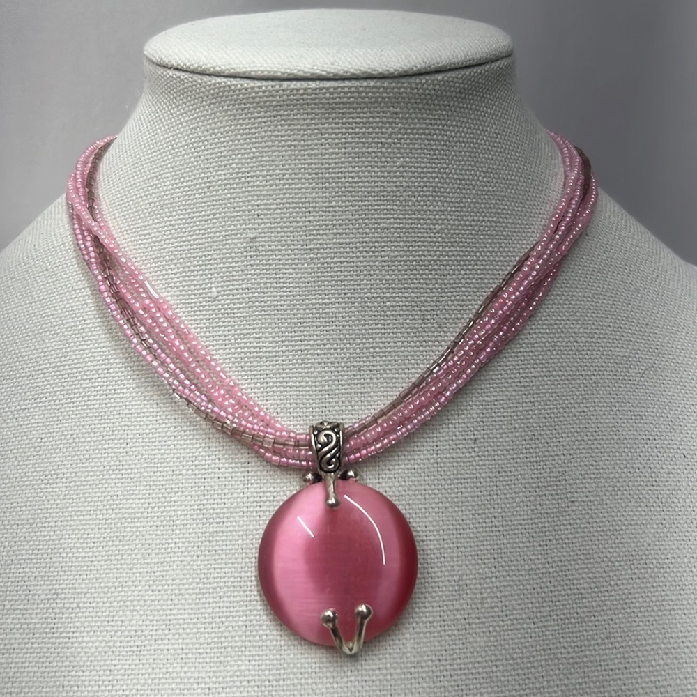 Pretty pink 5 strand and one silver strand necklace with pink pendant 16”